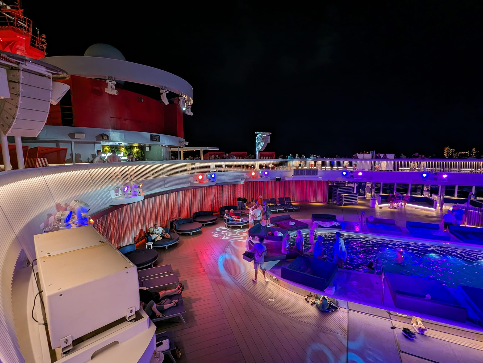 Virgin Voyages cruise pool deck at night