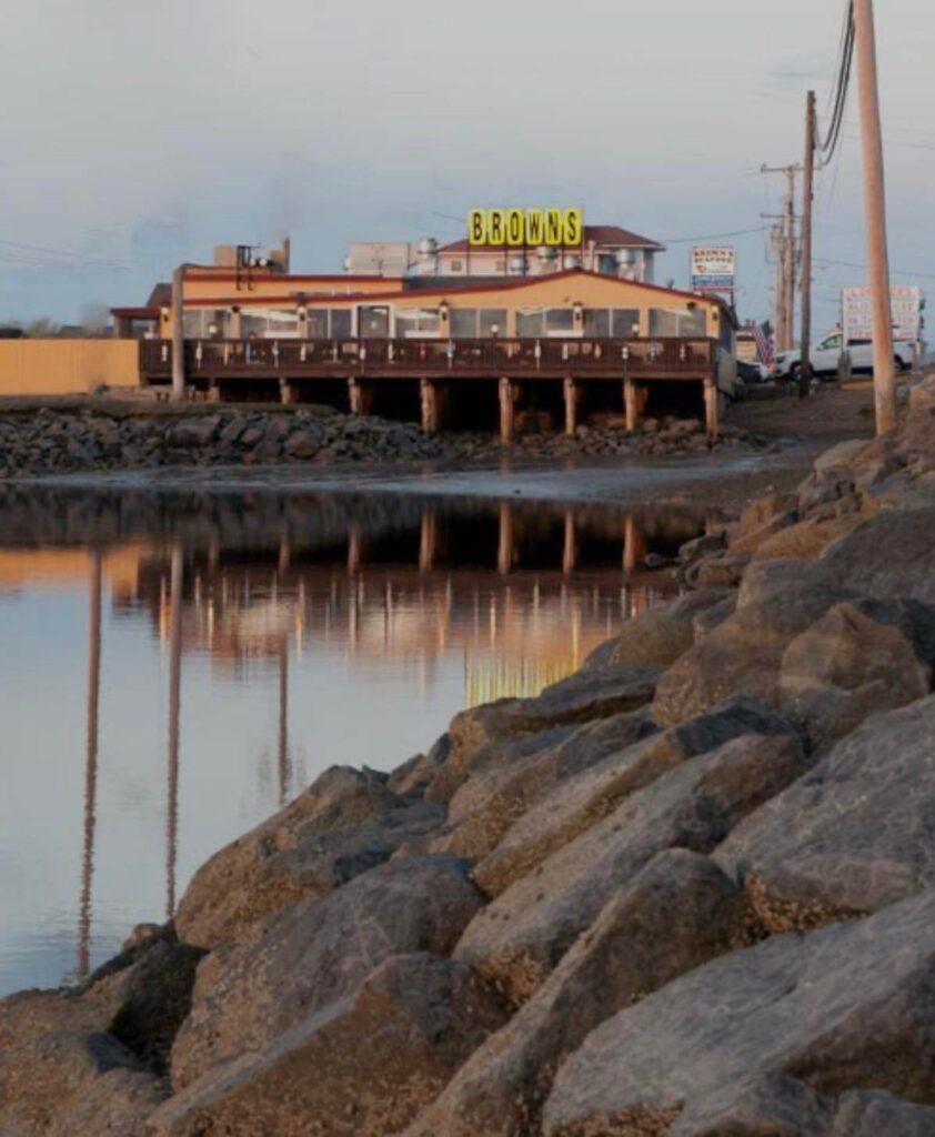 An outside vew of Browns Lobster Pound in Seabrook, NH showing the outside deck over the water