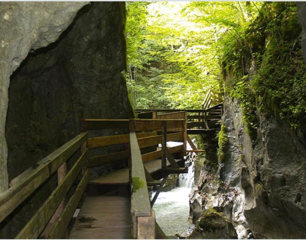 A photo of the walkway at the Flume Gorge in New Hampshire with a few of the waterfall below