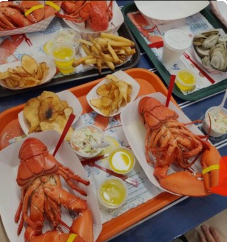 A two lobster Dinner at Markey's lobster pool with drawn butter and french fries with a side of steamed clams